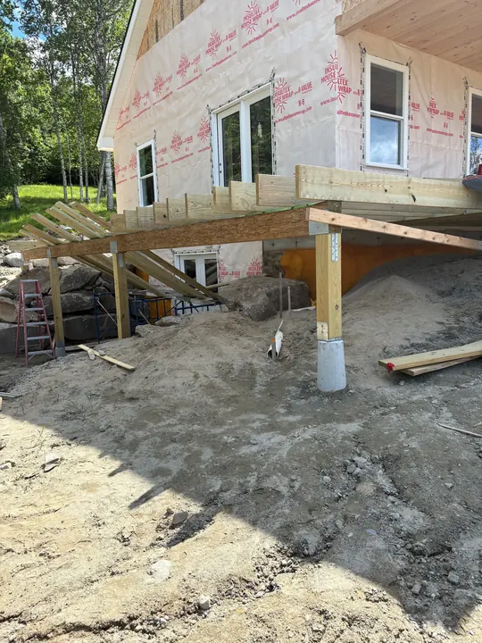 Raised deck framing on posts and concrete footings