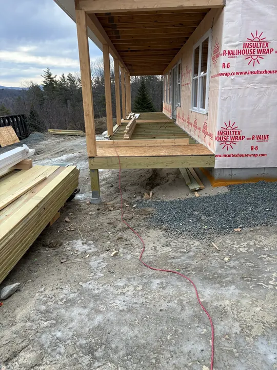 Decking boards being laid on a covered porch