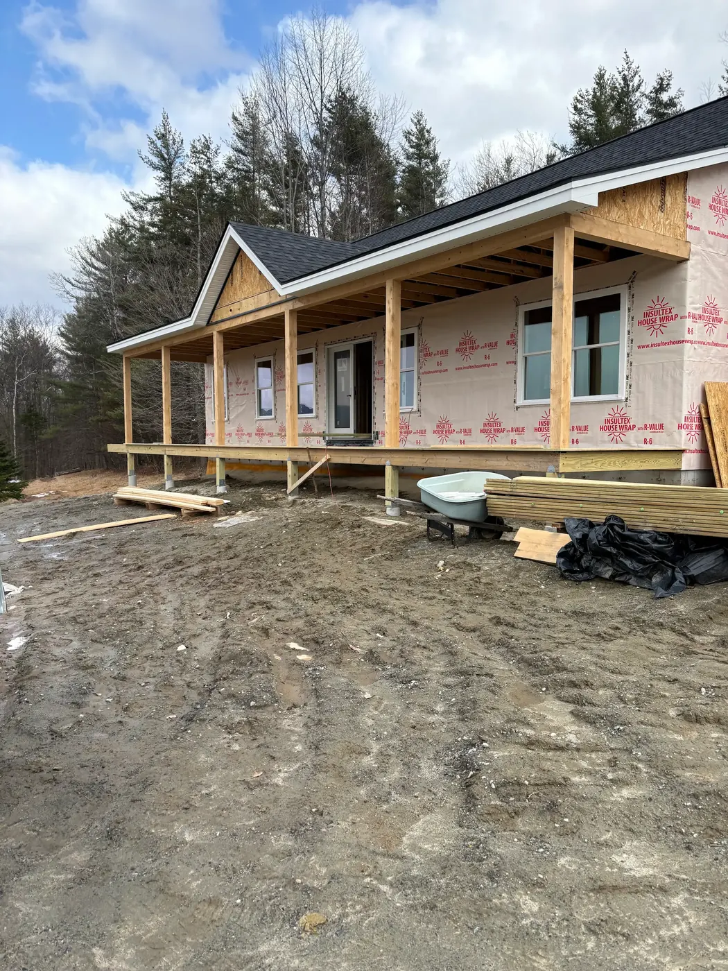 New covered porch running across the front of a house