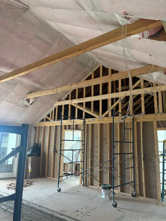 Insulation in a vaulted ceiling above new wall framing