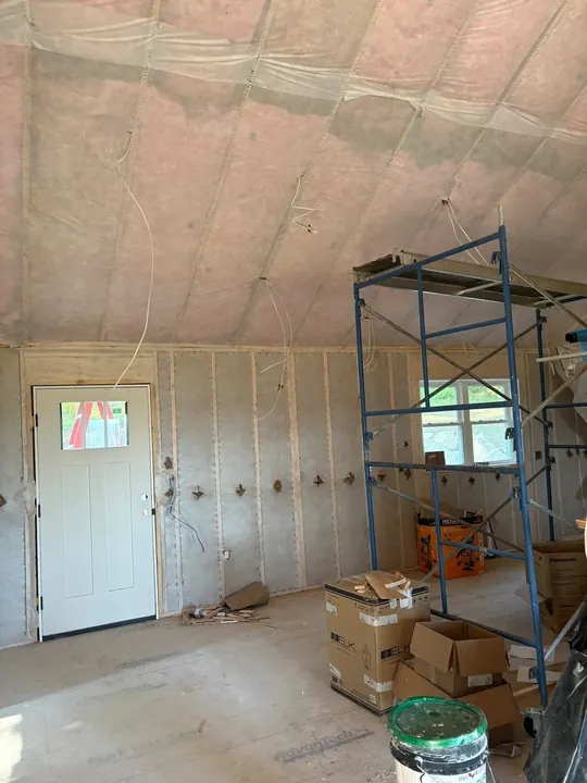 Insulated walls and ceiling covered with vapor barrier